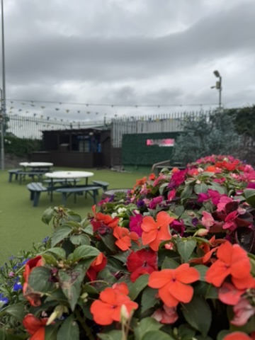 Orange flowers and tables at The Garden